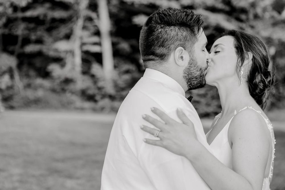 A romantic outdoor wedding ceremony captured in black and white.