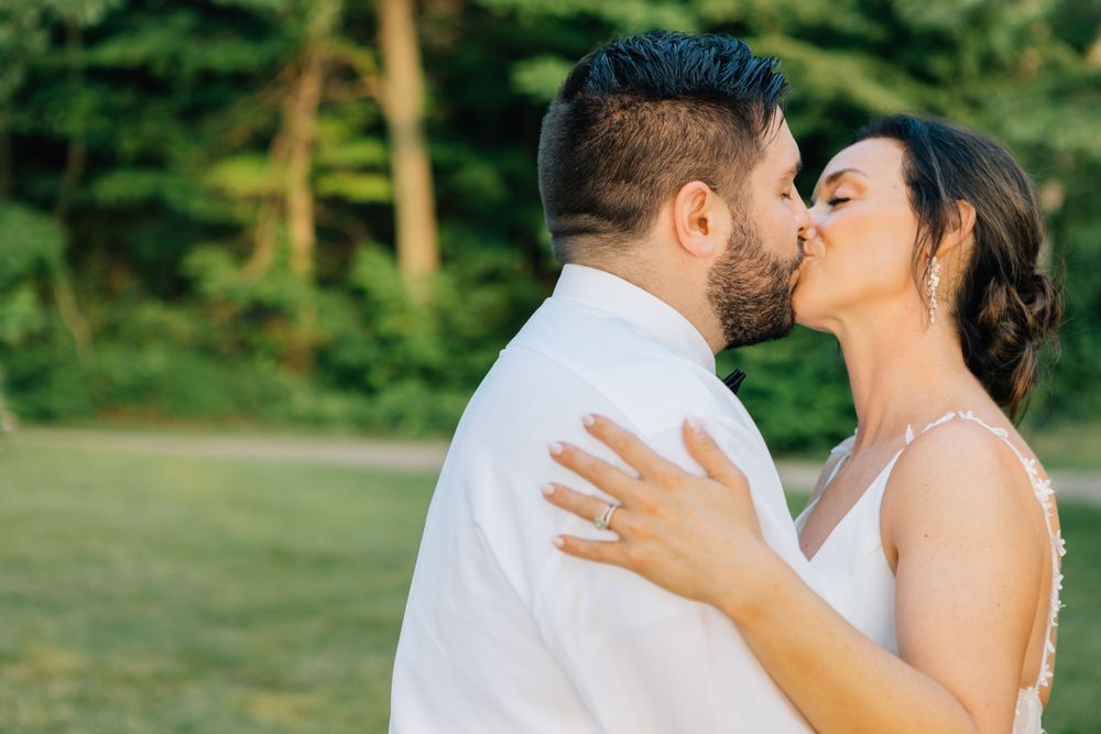 A romantic outdoor wedding moment captured under natural lighting.