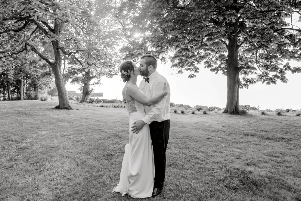 A series of black and white wedding photos taken in a scenic outdoor location.