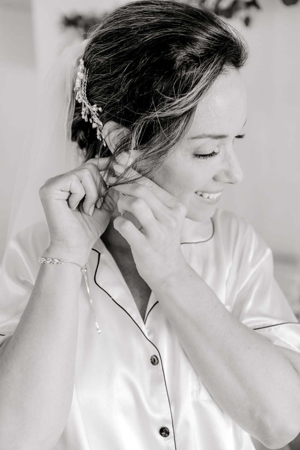 Close-up shots of wedding day preparation in soft black and white tones.