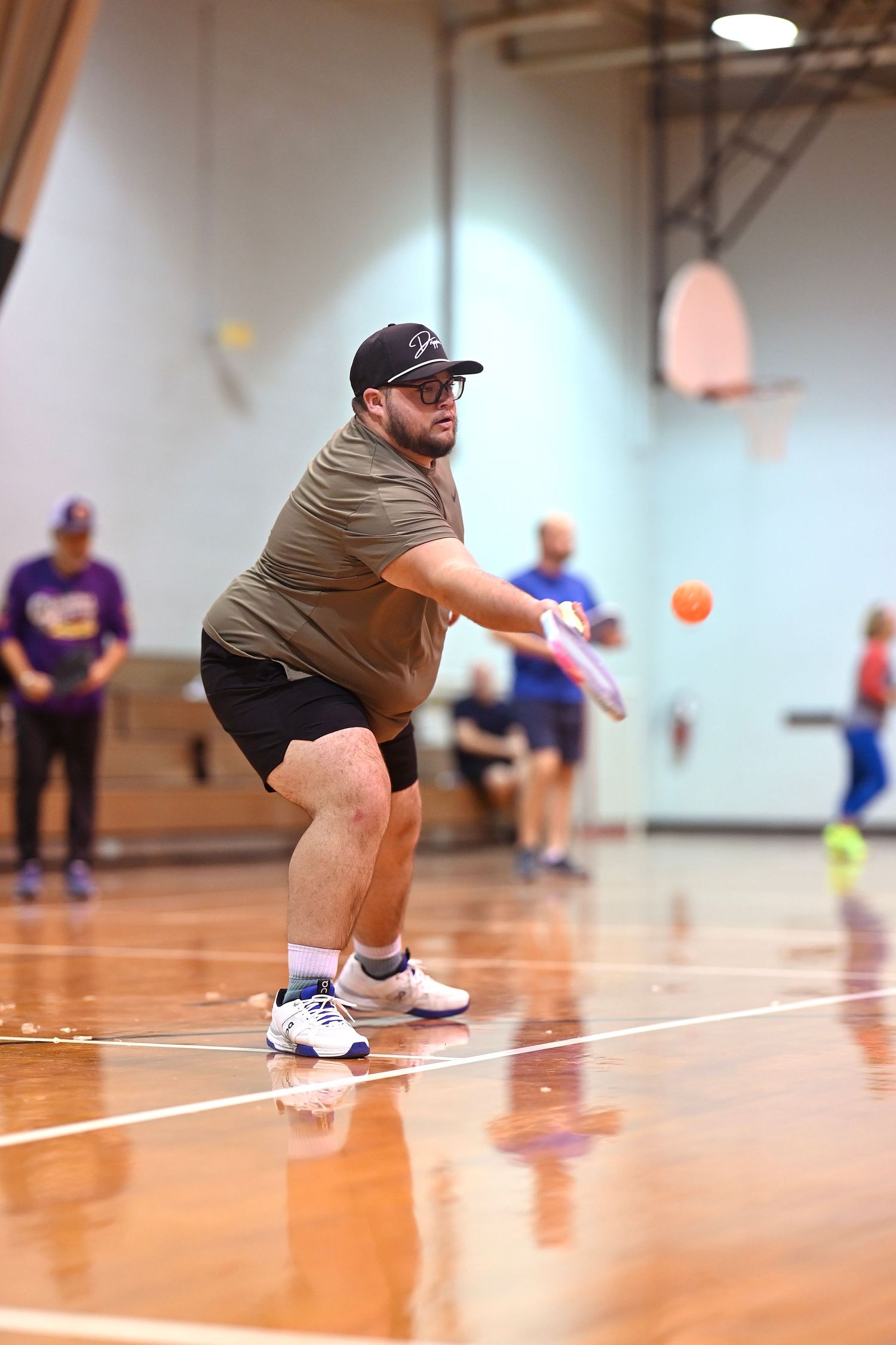 A player hits a ball to return it to opponents in a game of pickleball in Chicago