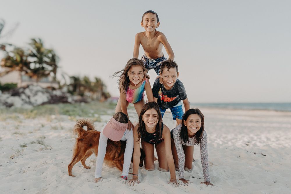 Friends and dog having fun at a beach photoshoot photoshoot in Puerto Morelos.