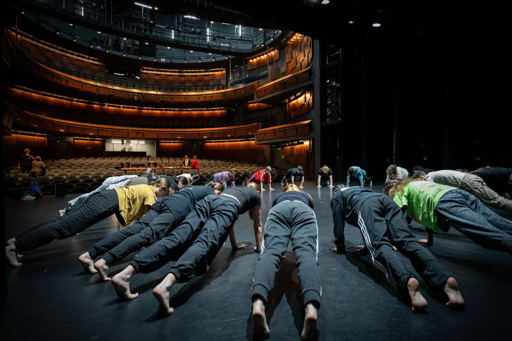 QL2 Dance's Quantum Leap ensemble warming up  on stage at the Canberra Theatre's Playhouse.