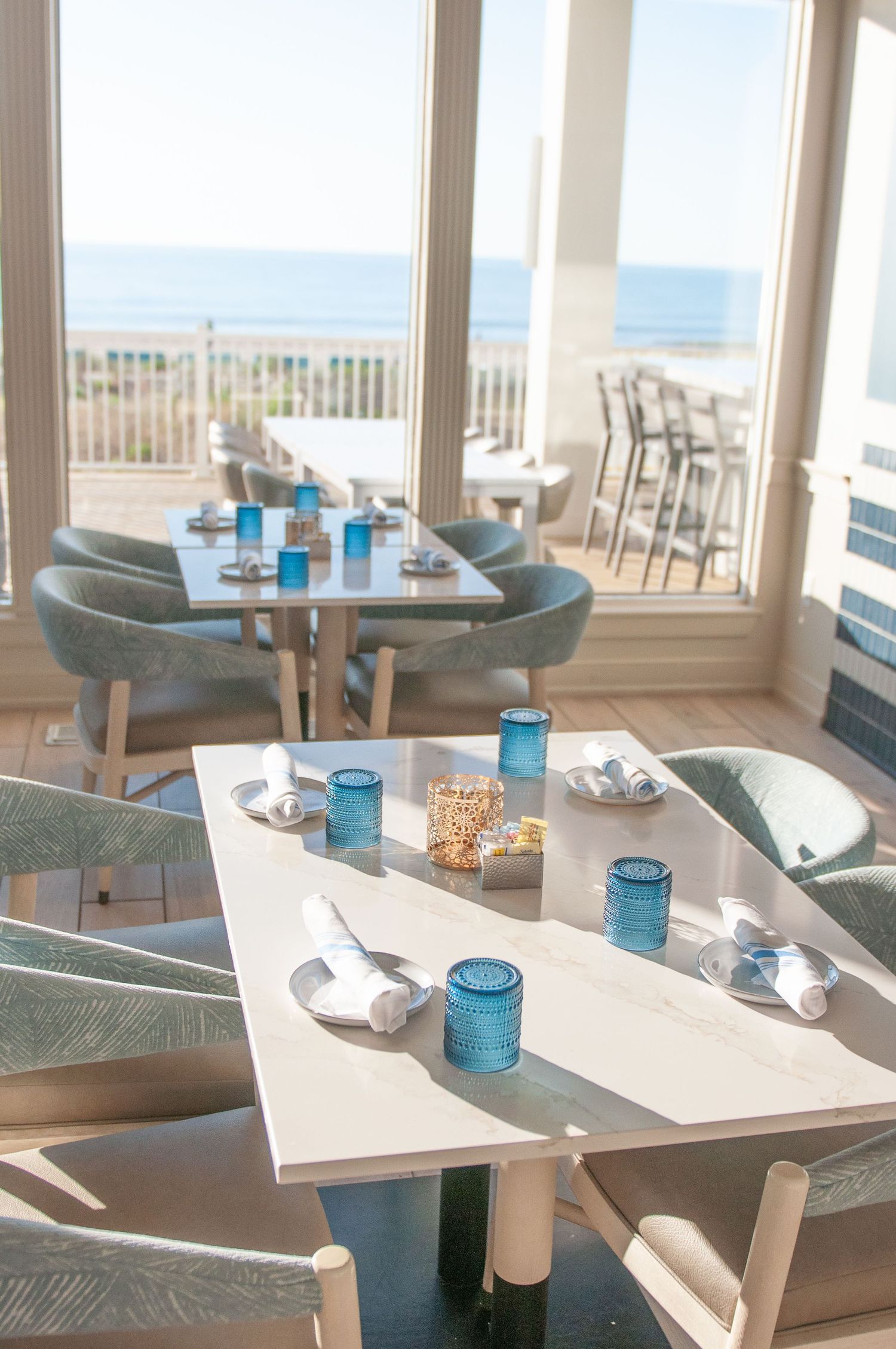 Breakfast place setting in a hotel restaurant overlooking the beach and sea