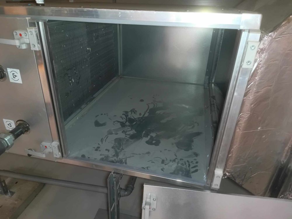 Industrial ventilation system components showing metal surfaces and installation details.