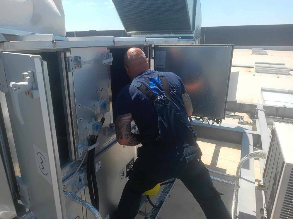 Maintenance work being performed inside an industrial ventilation system.