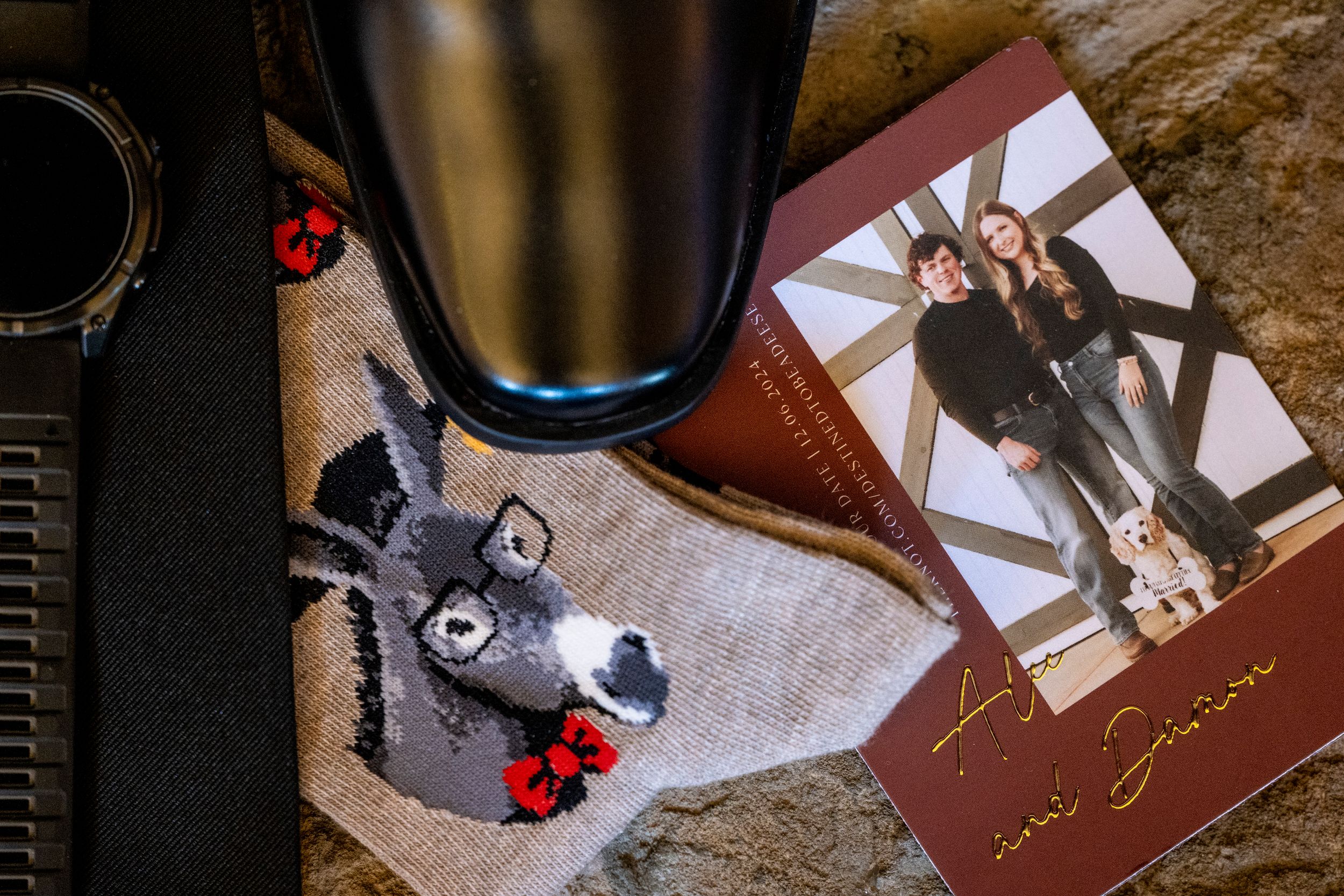 Wedding details flatlay with stuffed animal and photographs.