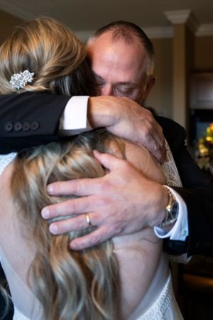 An emotional embrace during a wedding moment.