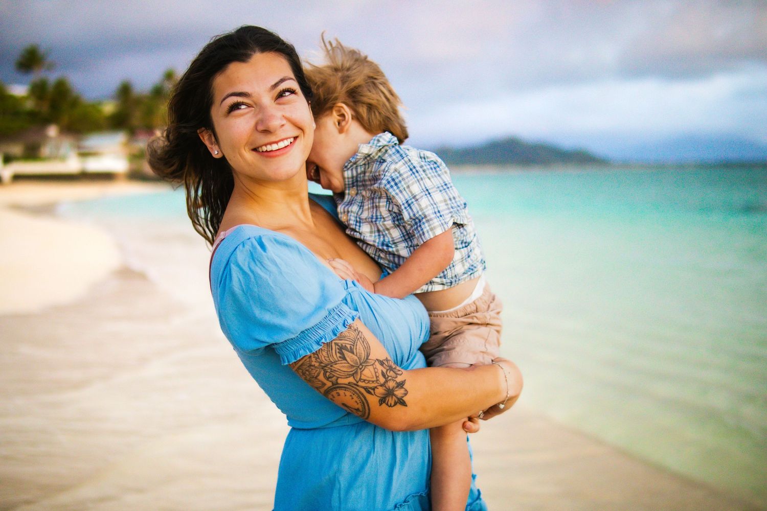 Mom holding her baby at the beach during sunrise — tender Hawaii family photo by Live Tribe Media.