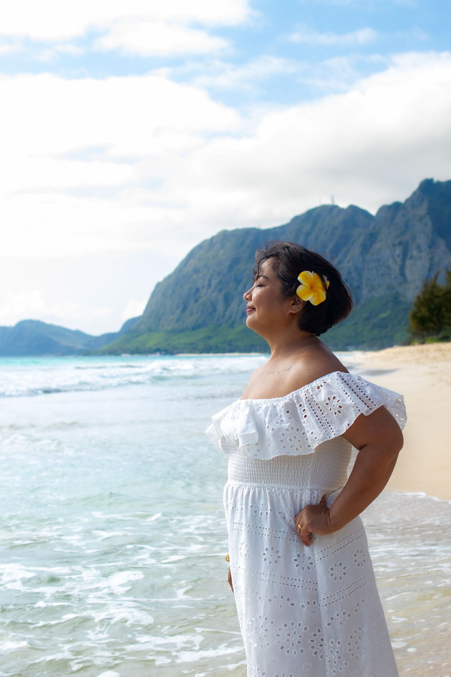 Woman gazing into the ocean at sunrise — serene Hawaii beach portrait by Live Tribe Media.
