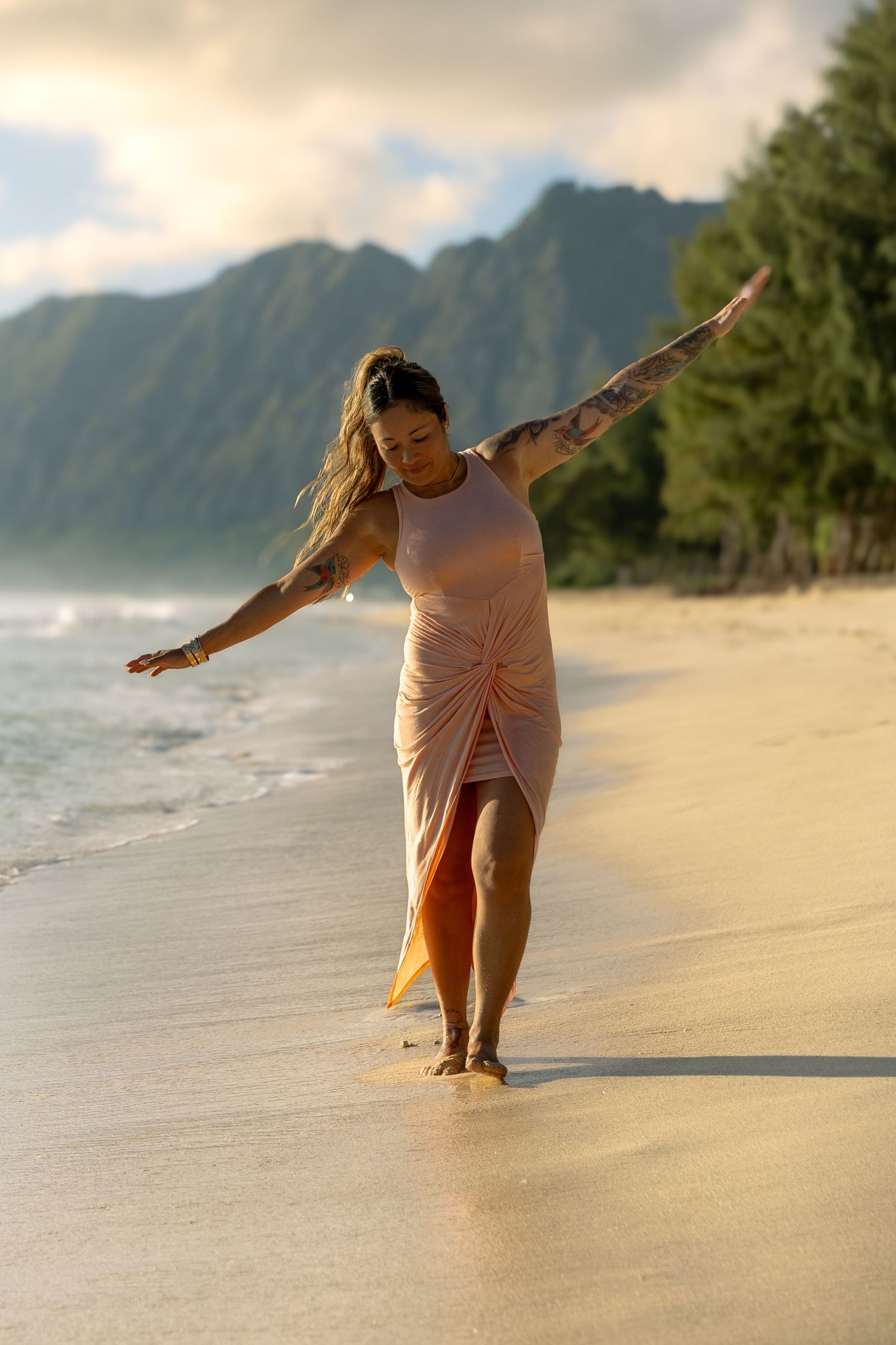 Mom walking alone along the beach at sunrise — peaceful Hawaii lifestyle photo by Live Tribe Media.