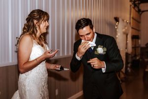 Candid reception moments captured as newlyweds interact at their dinner table.