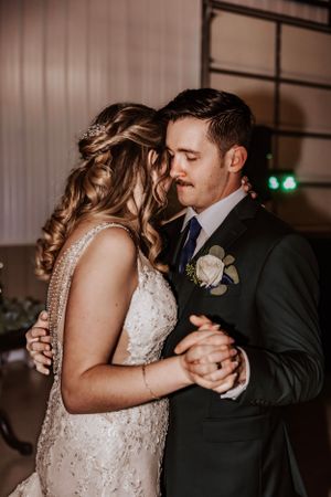 Couple shares a romantic slow dance during their wedding reception.