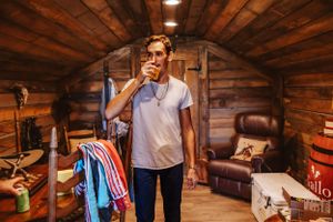 Interior of wooden barn venue with warm lighting and rustic decorative elements.
