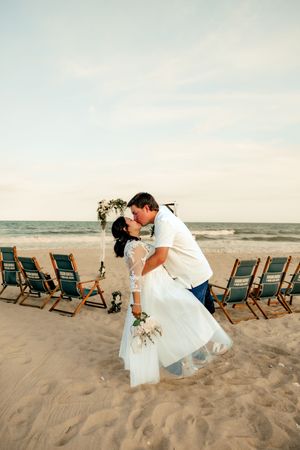 Couple sharing a romantic dip kiss at topsail beach North Carolina.