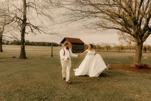 A series of romantic wedding photos showing a couple in white attire walking through an autumn field at sunset.