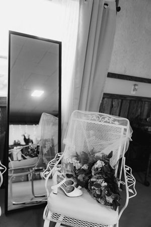 A black and white photo sequence showing a white wicker chair with floral decorations in different arrangements.