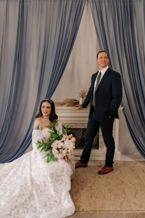 Wedding photography setup with elegant blue drapes and classic decor.