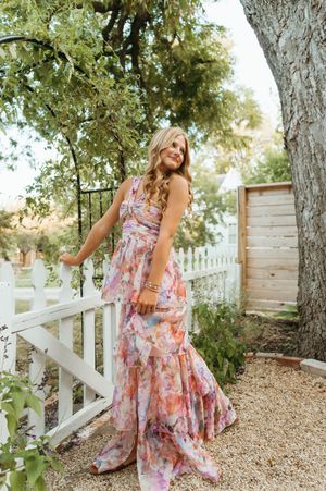A series of photos showing brown cowboy boots paired with a white dress against a rustic wooden floor.