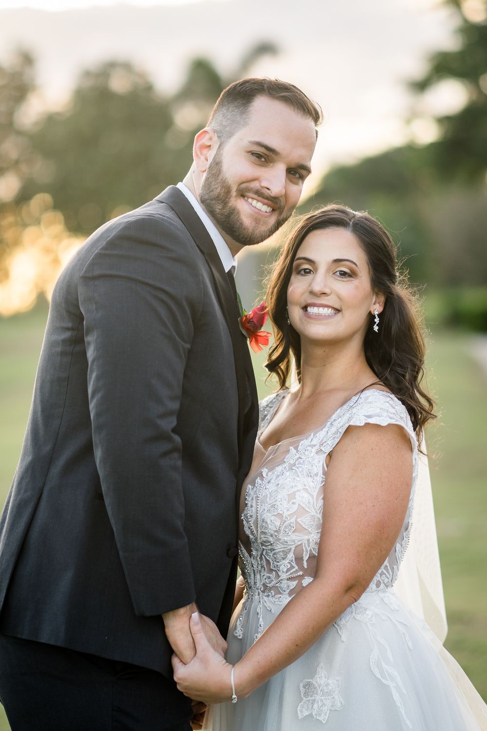 Couple shares intimate moment in formal wedding attire during golden hour outdoor portrait session.