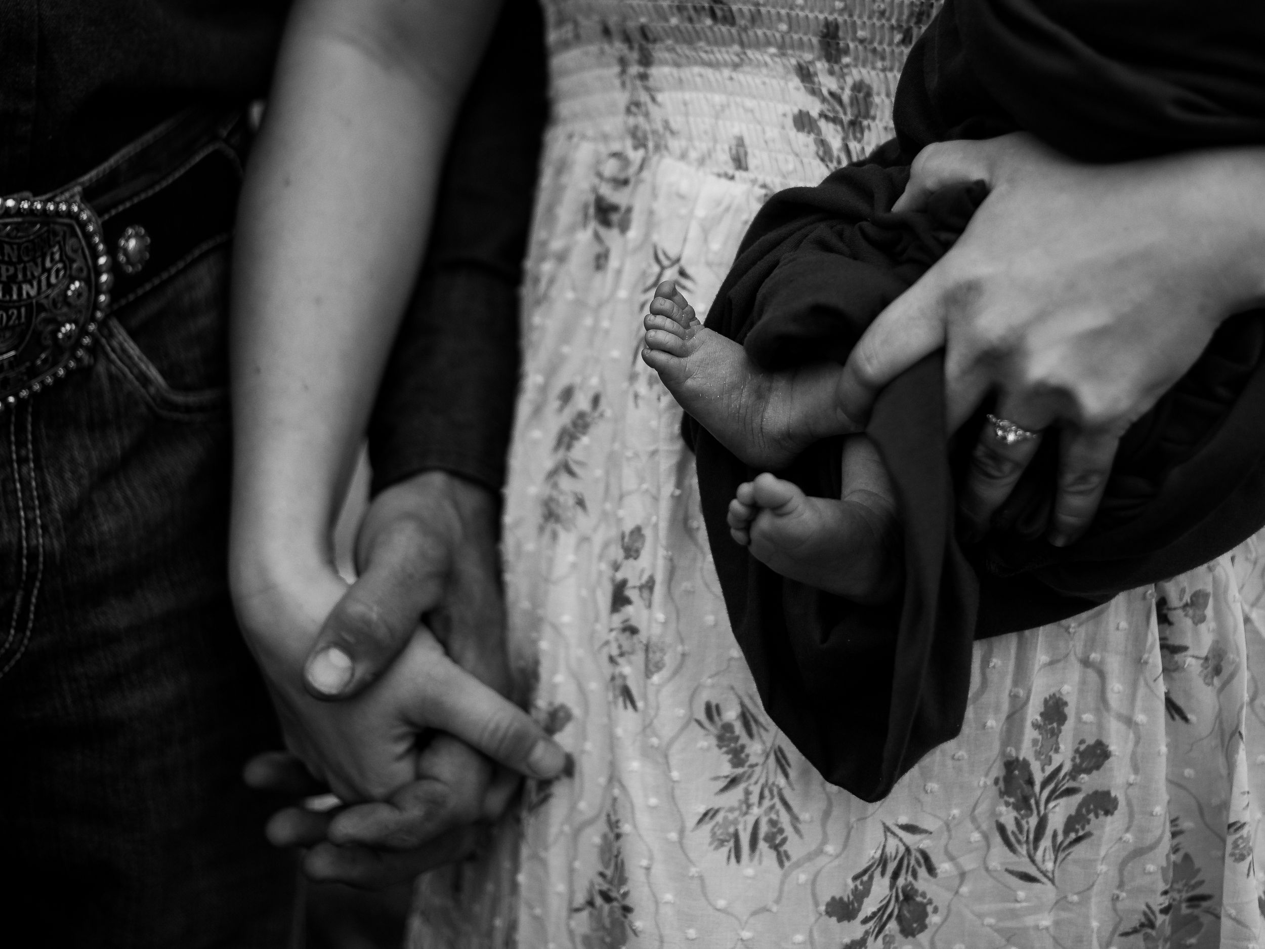 Close-up view of hands holding black and white photographs in a sequence.