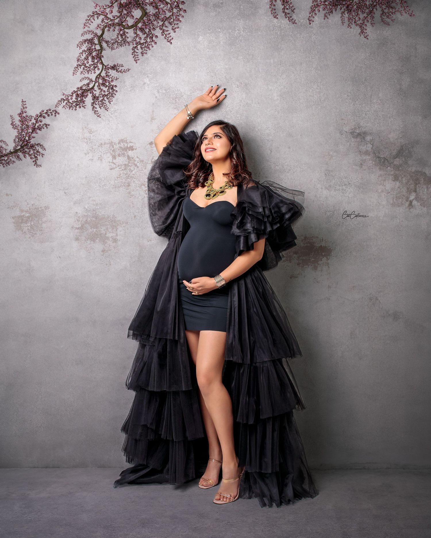 Glamorous mum-to-be in a black gown, captured by Caz Captures.