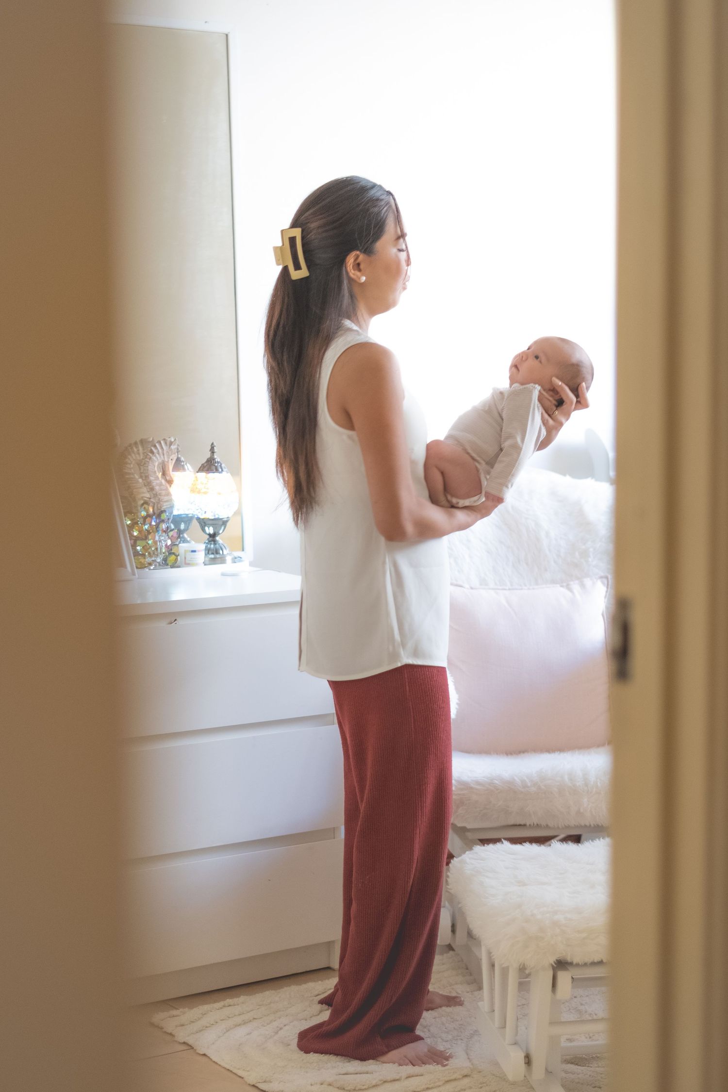 Interior lifestyle photos showing someone with a white top and red pants.