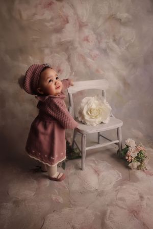 toddler standing holding on to chair milestone photoshoot