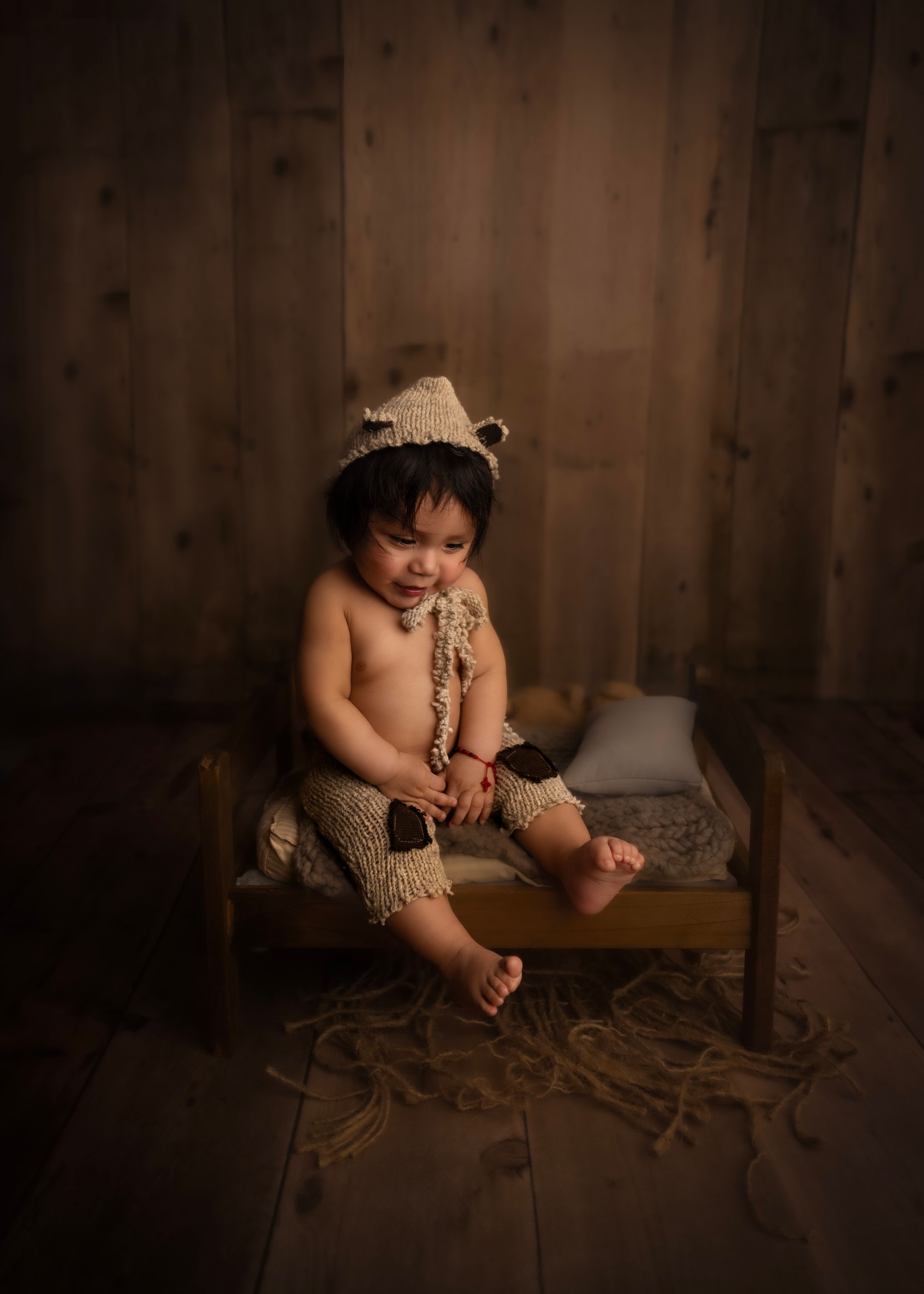 Child sitting on wooden floor milestone photoshoot