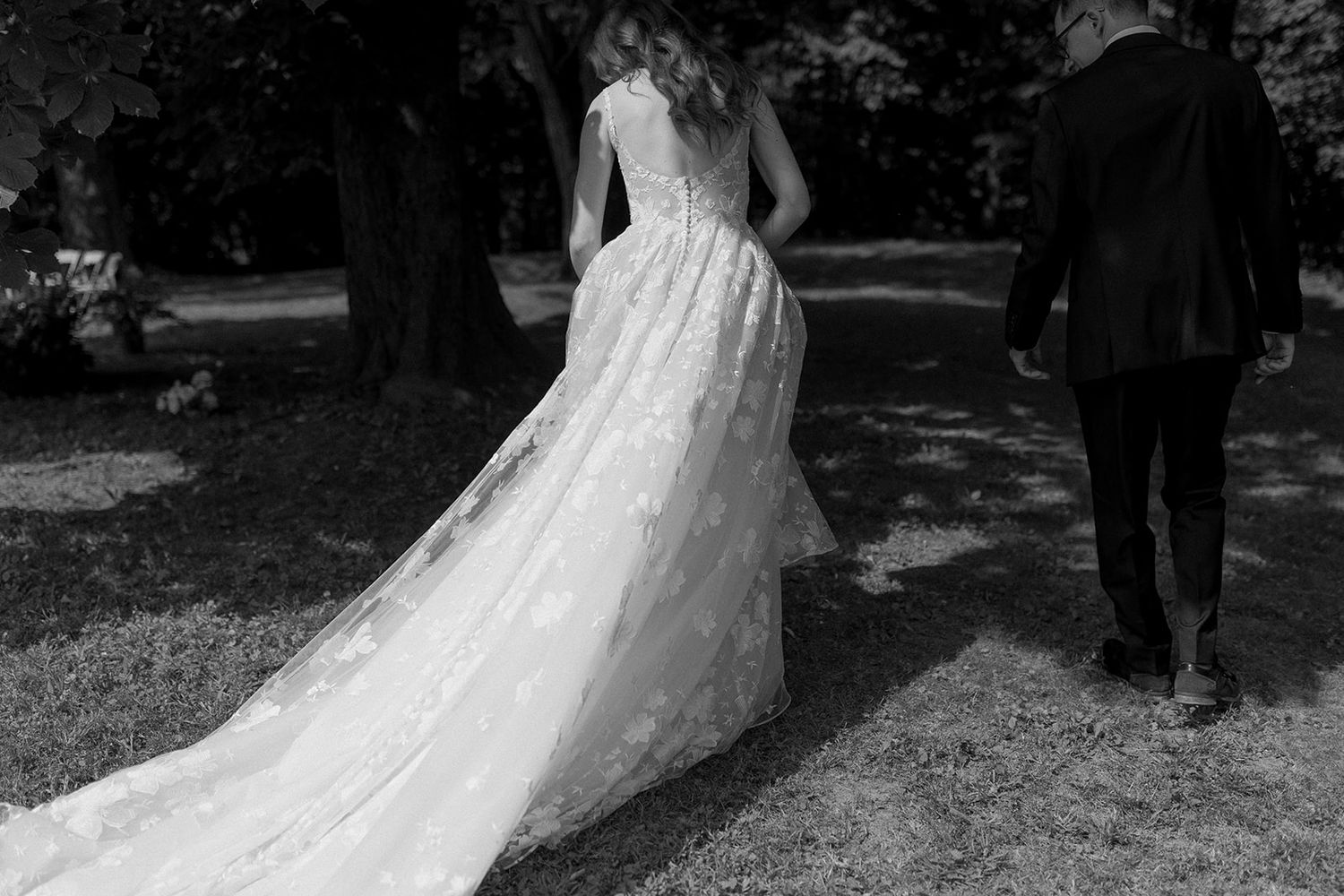 A wedding couple poses in black and white photography outdoors.