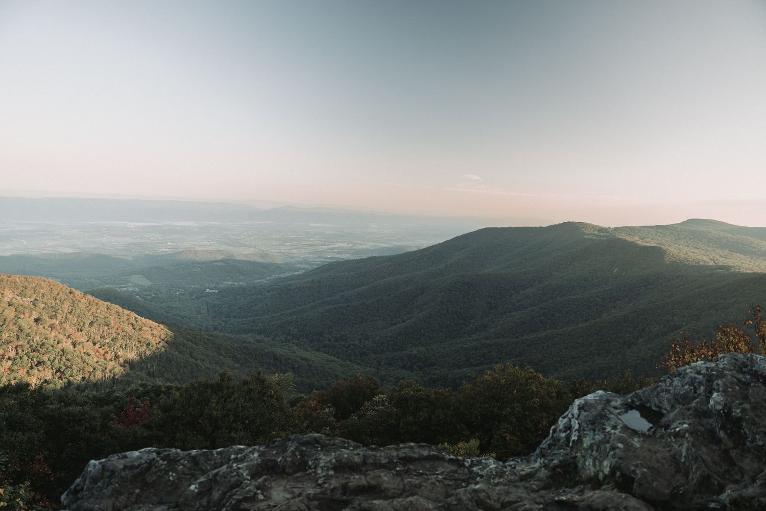 Expansive mountain landscape with layered ridges stretching to the horizon.