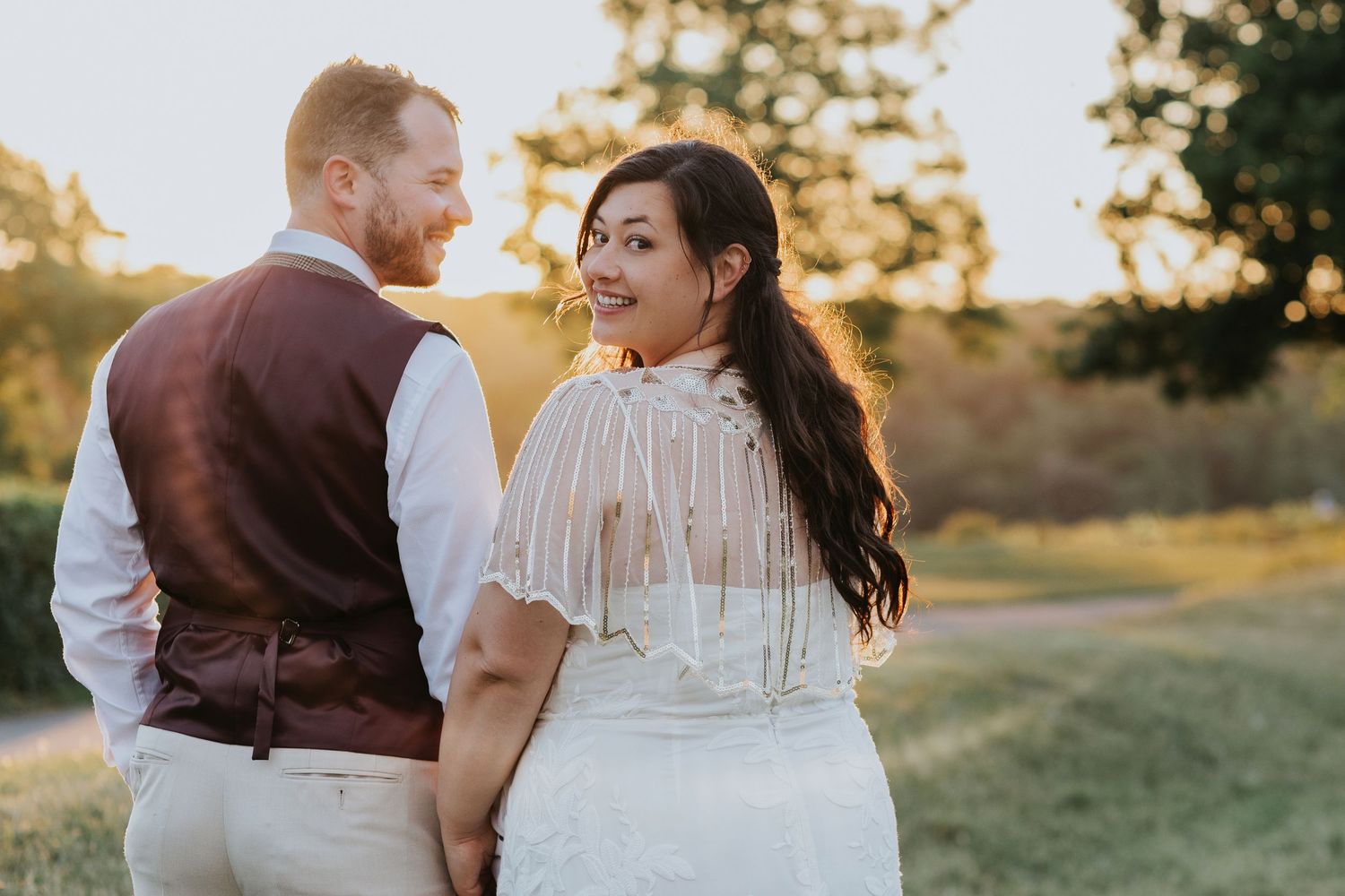 Golden hour wedding photos capture intimate moments between newlyweds in rustic outdoor setting.