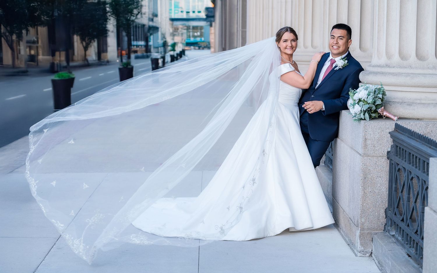 Elegant wedding photography series featuring a bride and groom posing near classical architecture.