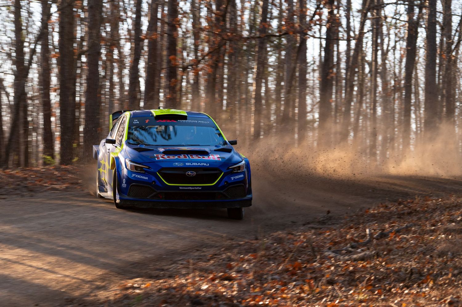 Series of blue sports car shots driving through an autumn forest.