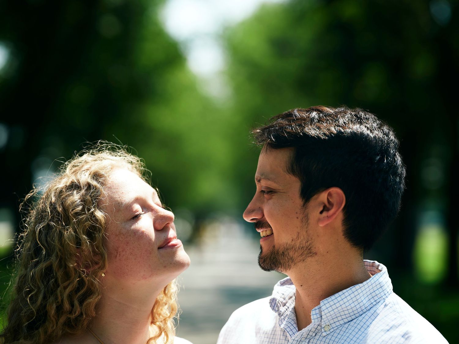 Romantic lifestyle photo of couple looking into the trees at the National Mall in Washington DC.
