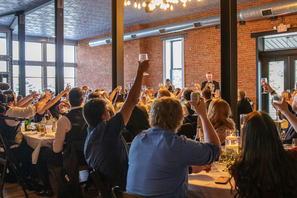 becky katzberg photography wedding reception with people toasting