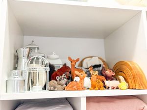 Shelf display of autumn decorations including pumpkins, lanterns, and fox plush toys.