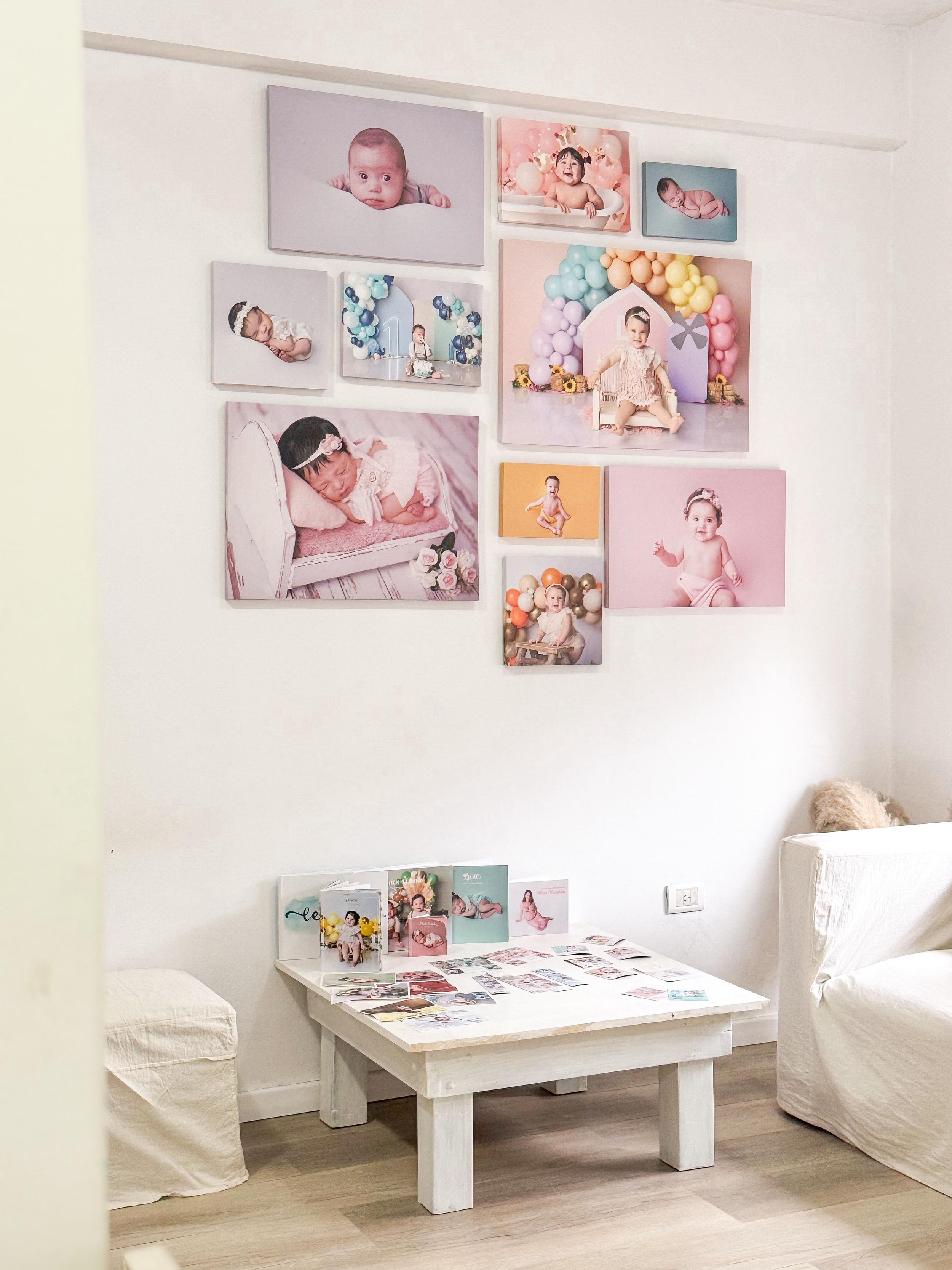 Photography studio wall adorned with pastel toned portraits and artwork displays.