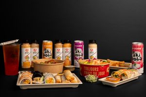 Display of Oki Poki beverages and Asian fusion food items on dark background.