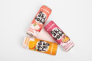 Collection of colorful Oki Poki drink cans showcasing different fruit flavors on white background.