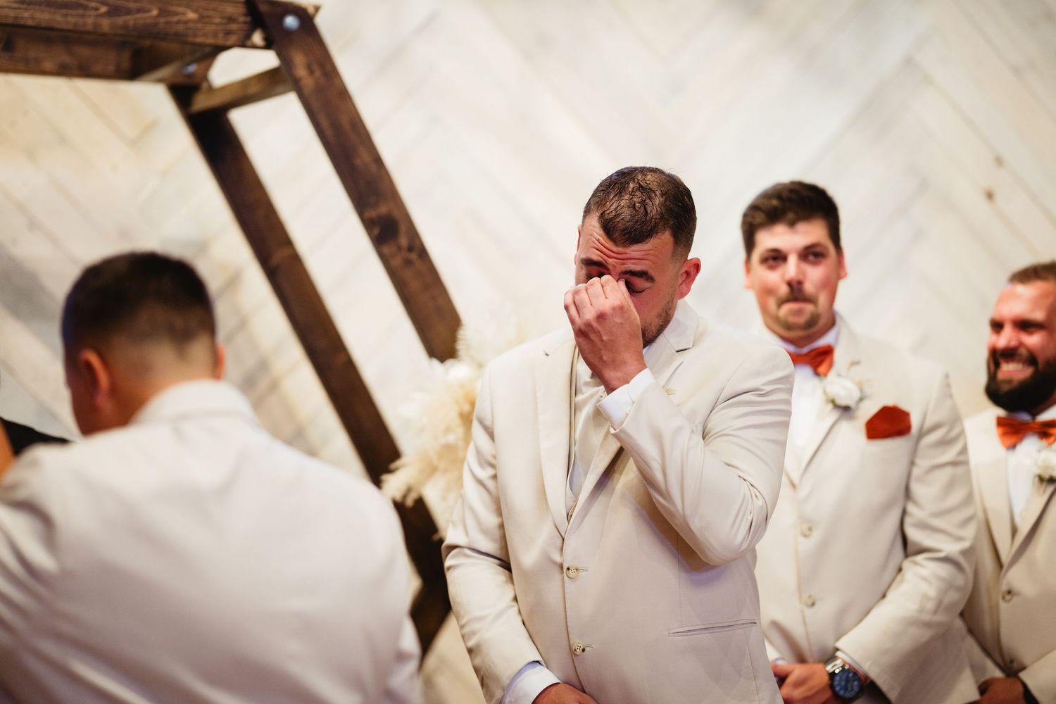 A collage of wedding celebration moments shows people in white suits hugging and expressing joy at a reception venue.