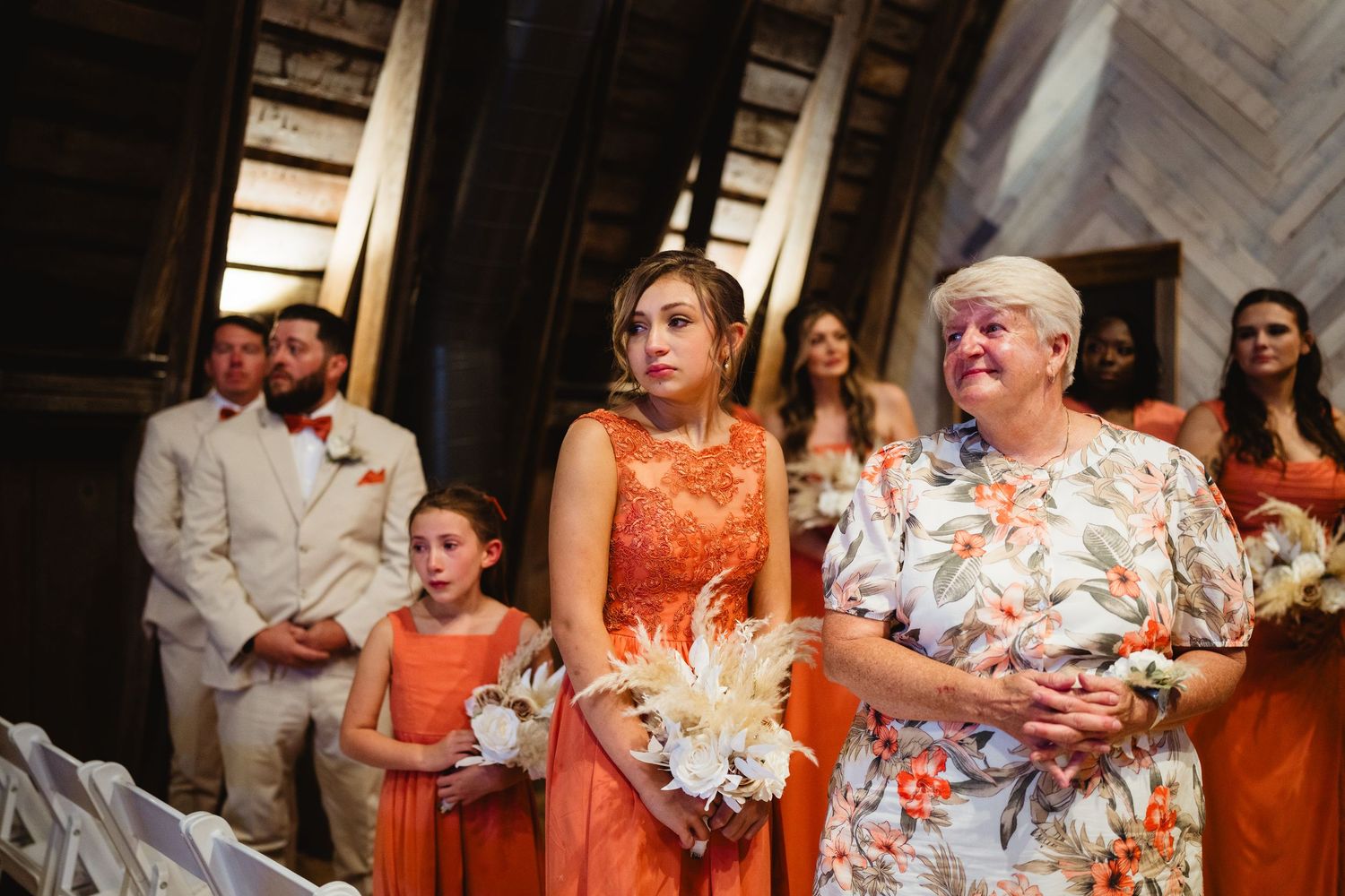 A collage of wedding celebration photos showing guests in coral and orange colored attire at an indoor venue.