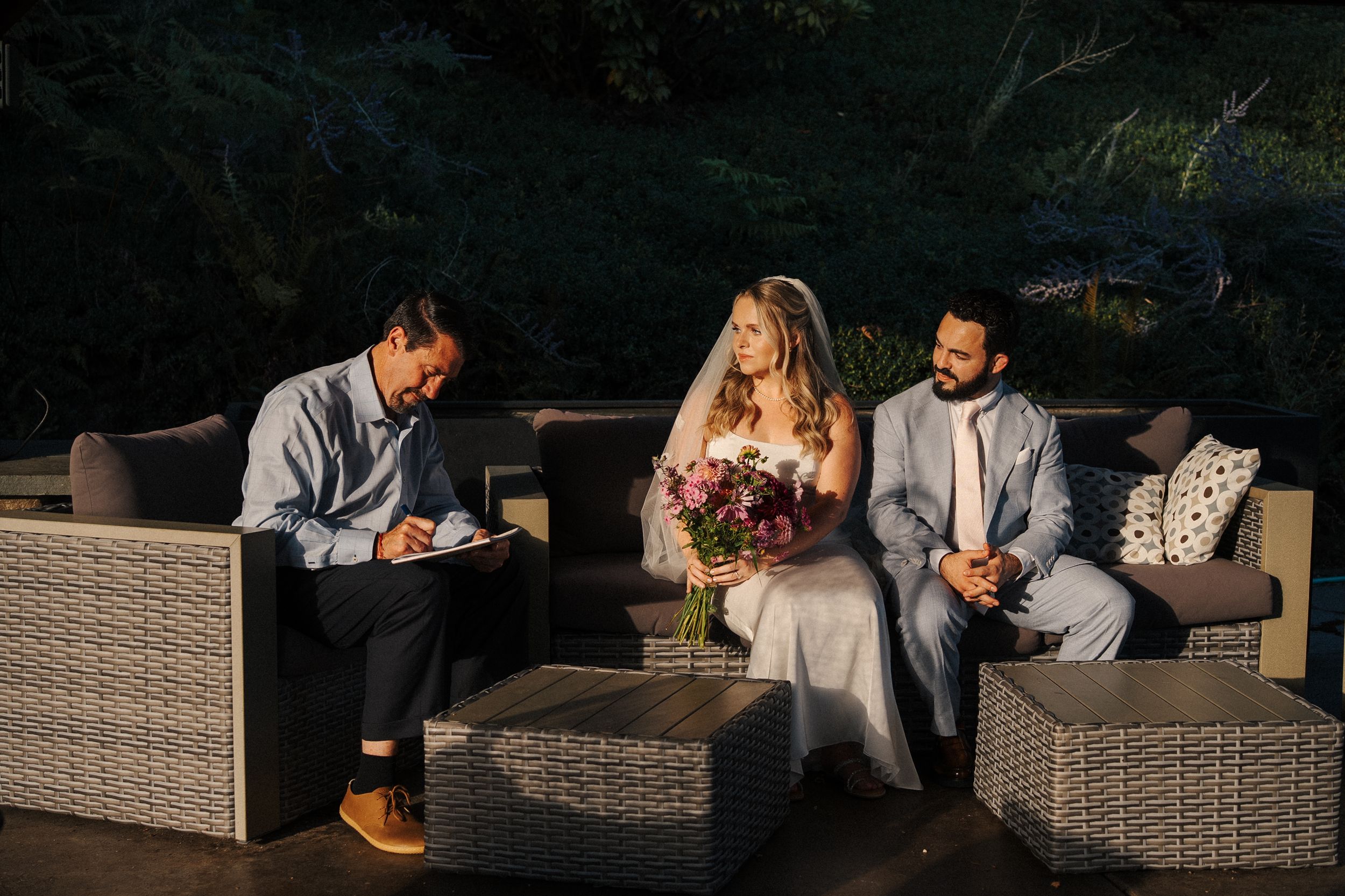 Stylish outdoor conversation set with wicker patio furniture and cushions arranged for entertaining on a deck or patio.