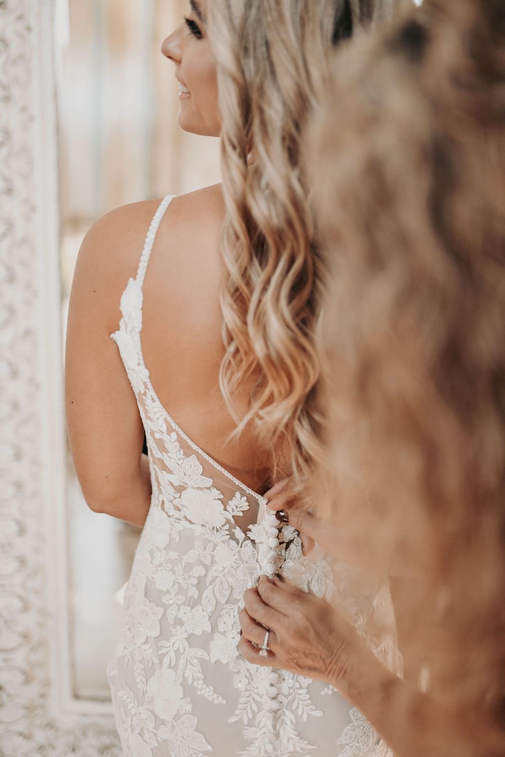 Bride preparing for her Whispering Oaks wedding with lace gown and bridal details