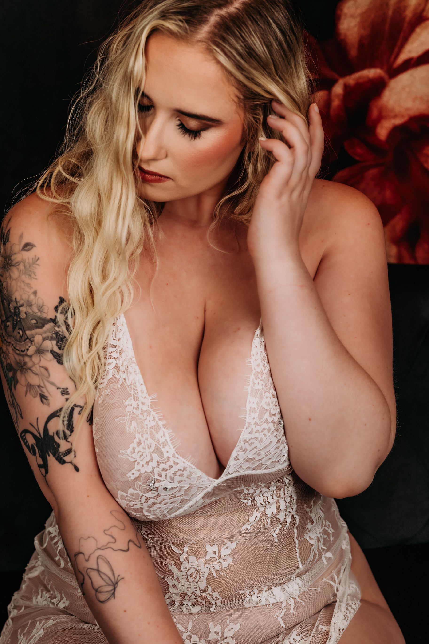 A close-up series of white lace lingerie details with visible floral embroidery patterns and delicate straps. Grand Rapids Boudoir Photograp