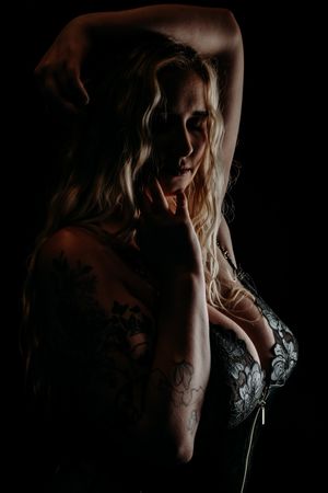 A dramatic series of black and white boudoir portraits showing a figure in shadow and moody lighting. Grand Rapids Boudoir Photography