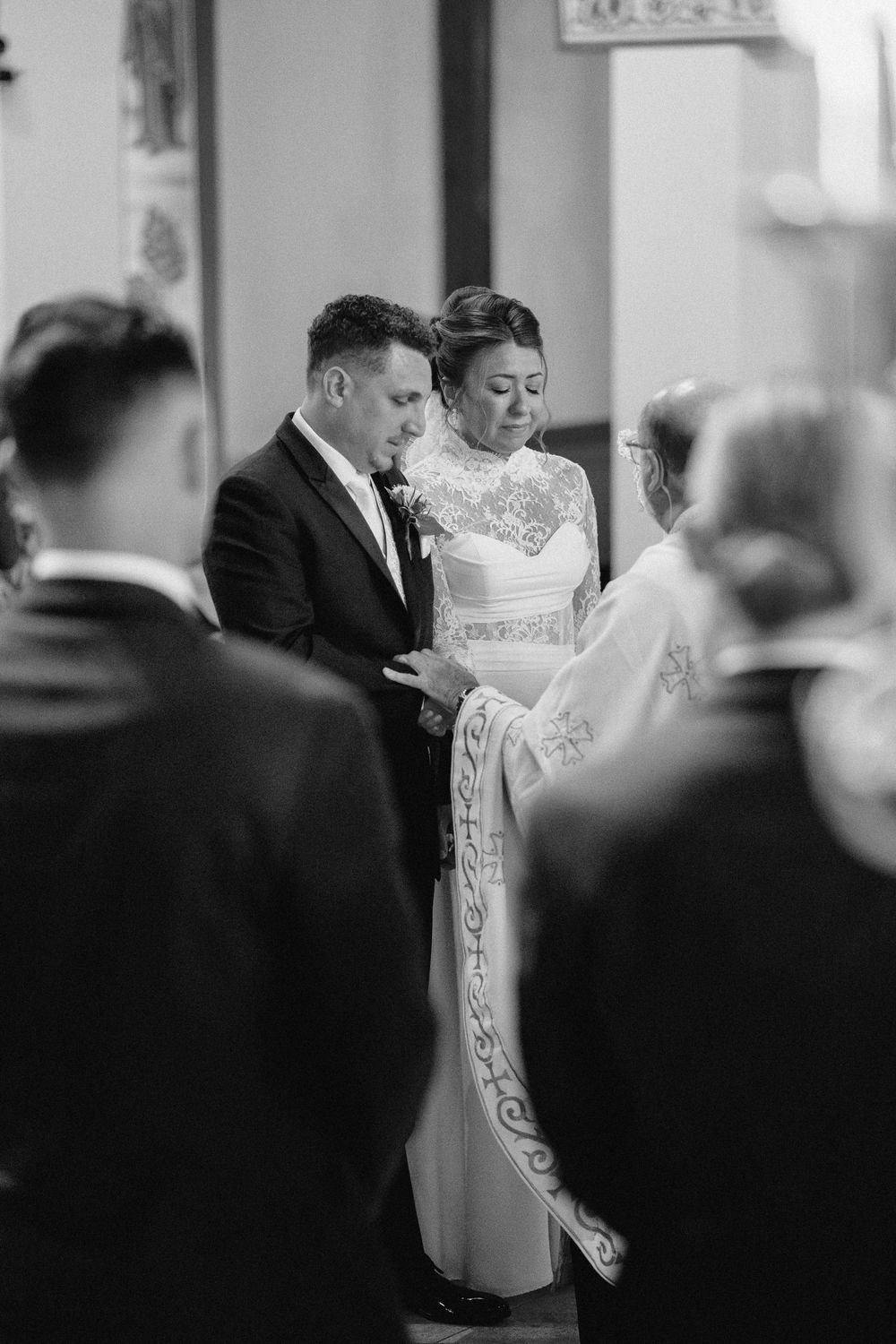 An elegant bride and groom sharing a graceful first dance at their wedding reception together in black and white.