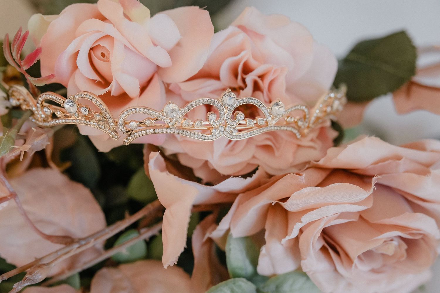 Delicate pink roses with lace details create an elegant wedding floral arrangement.