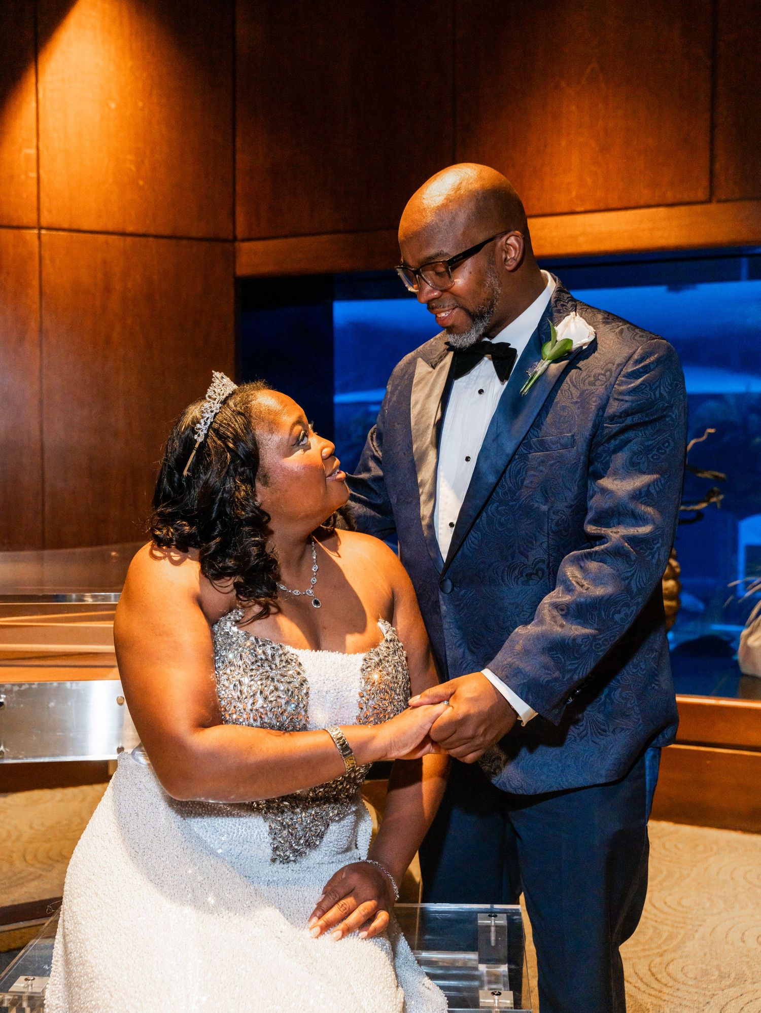 Romantic dance scene in an elegantly lit room with warm amber lighting in Raleigh, Nc