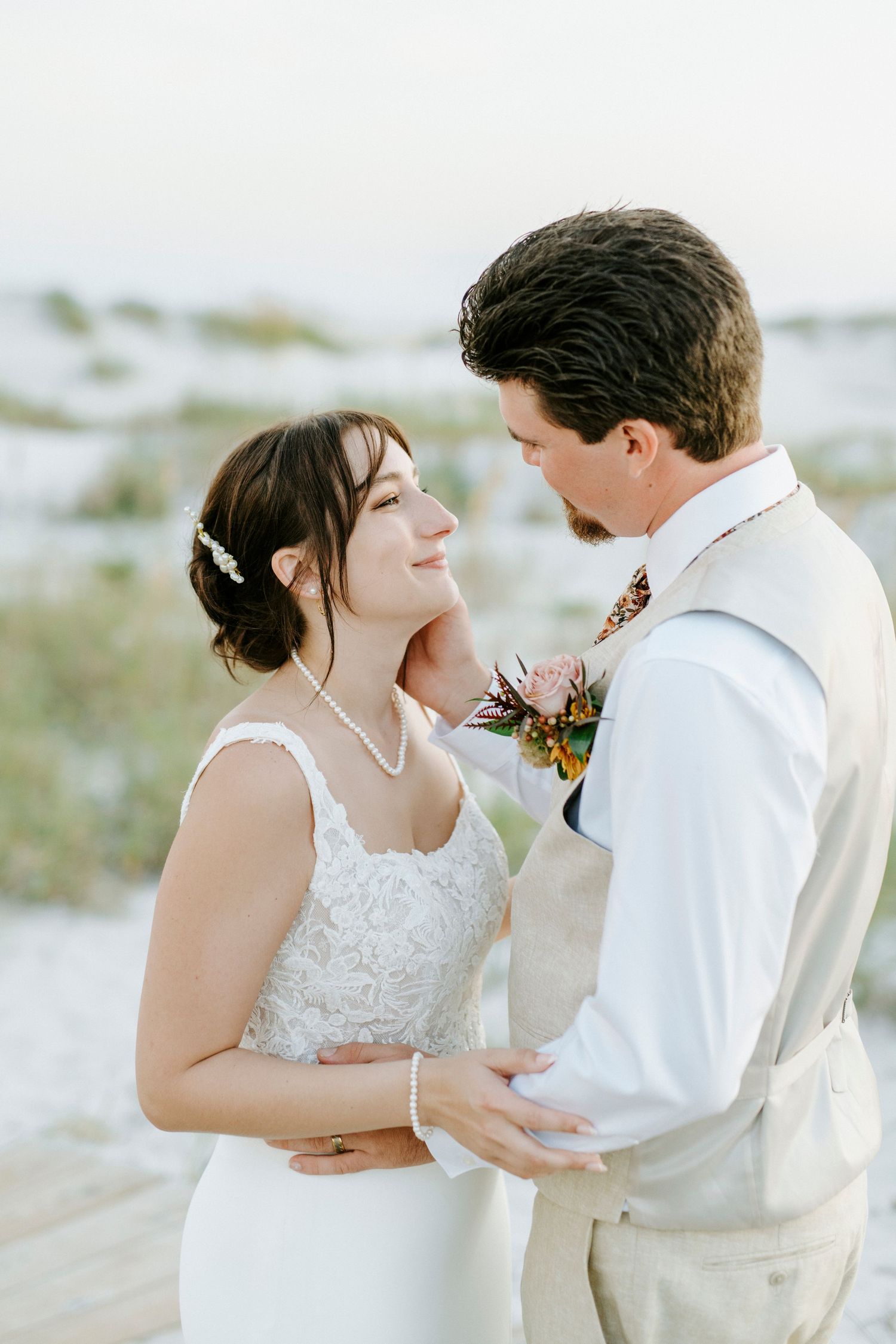A tender wedding moment captured in a series of close-up frames showing an intimate beach ceremony.
